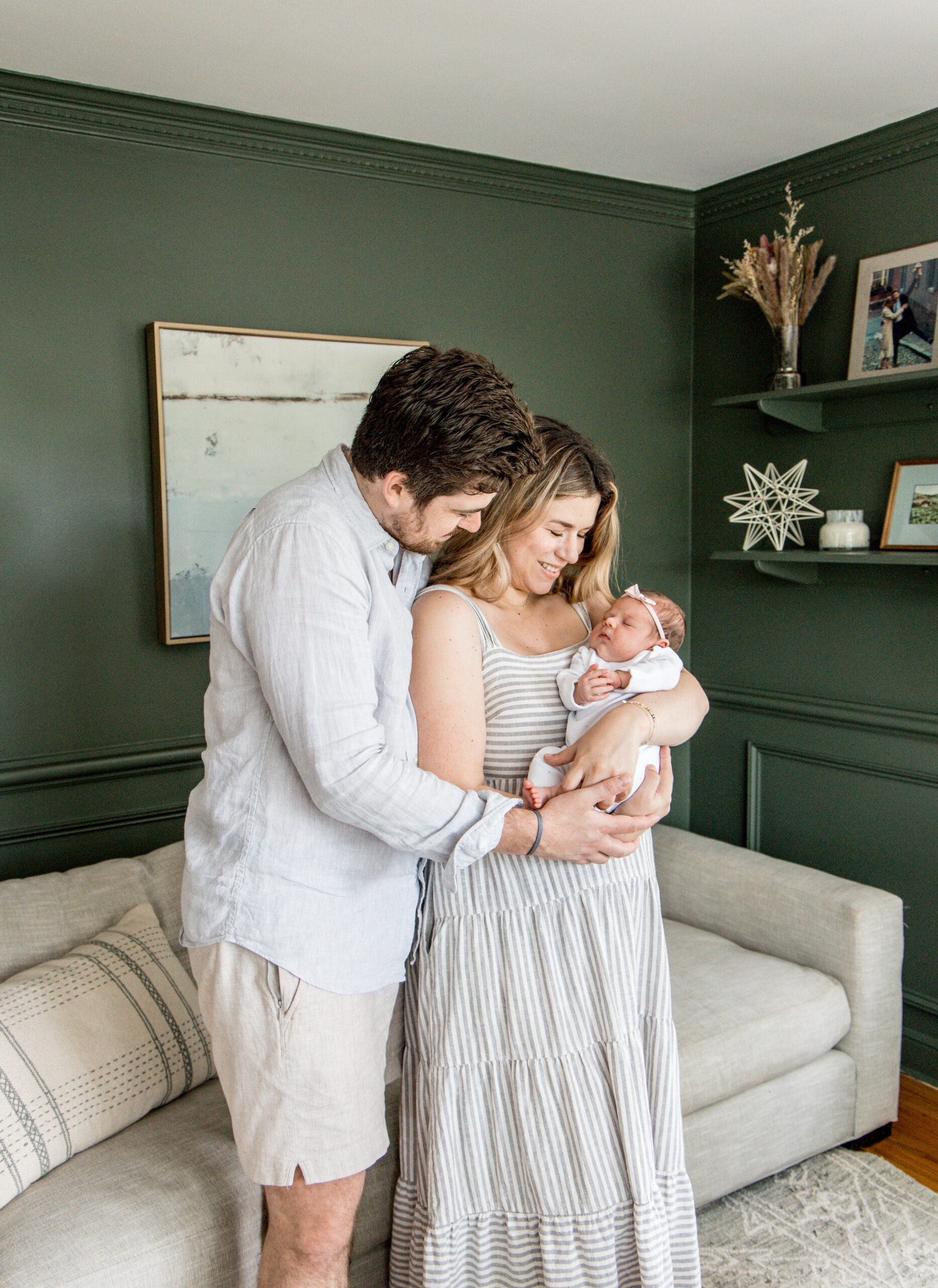 Parents lovingly looking at their newborn during an in-home lifestyle session in Fairfield County, CT
